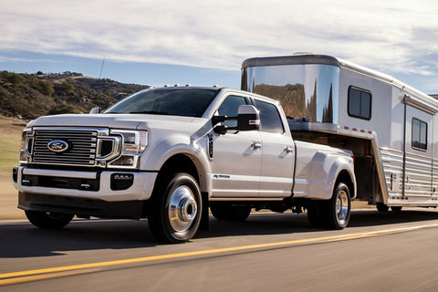 Ford truck pulling trailor on road