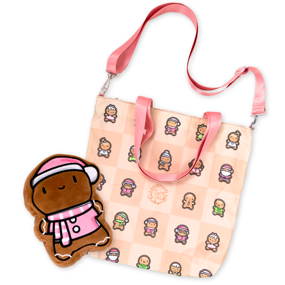 Pink tote bag with cartoon gingerbread characters and a gingerbread plush toy wearing pink winter attire.