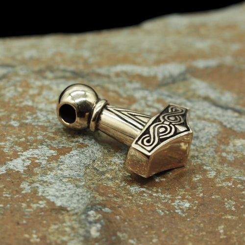 Bronze Runic Thors Hammer Replica on Rock