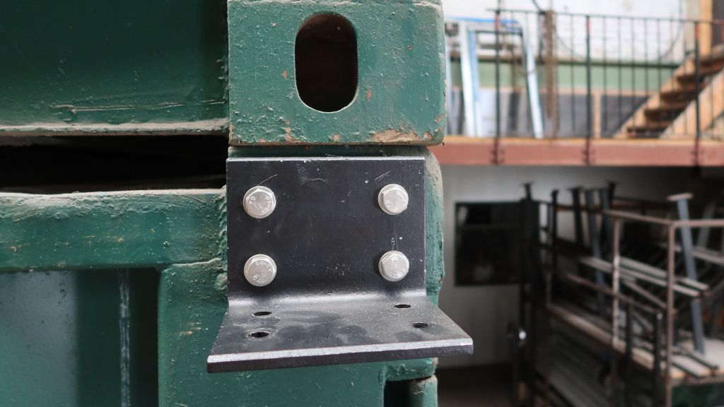 Angle iron bracket attached to a shipping container