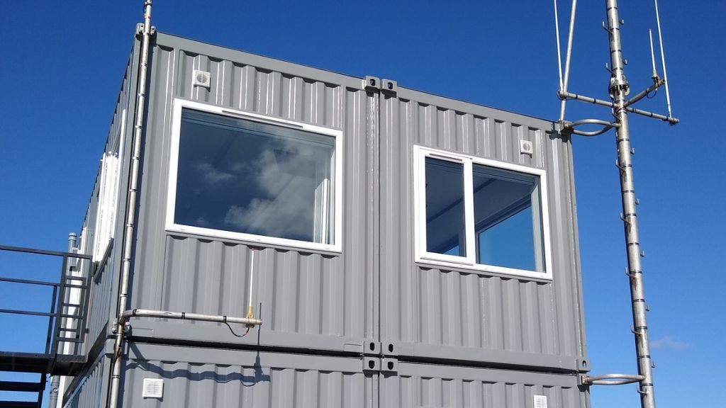 Comms masts mounted to a shipping container using Domino Clamps