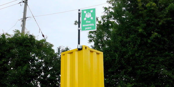 A safety sign mounted securely to the top of a shipping container