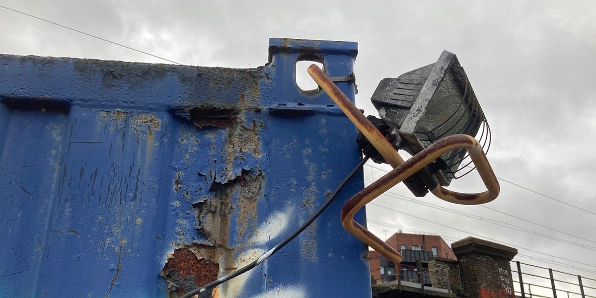 Floodlight attached to a shipping container using cable ties