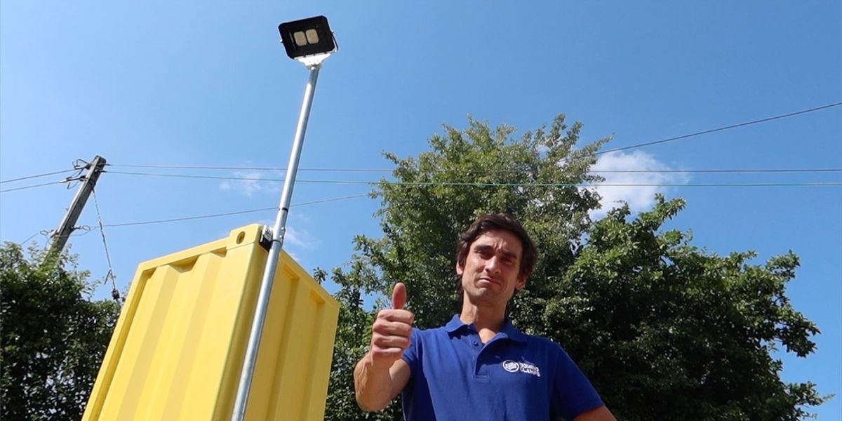 Attach a floodlight to a shipping container