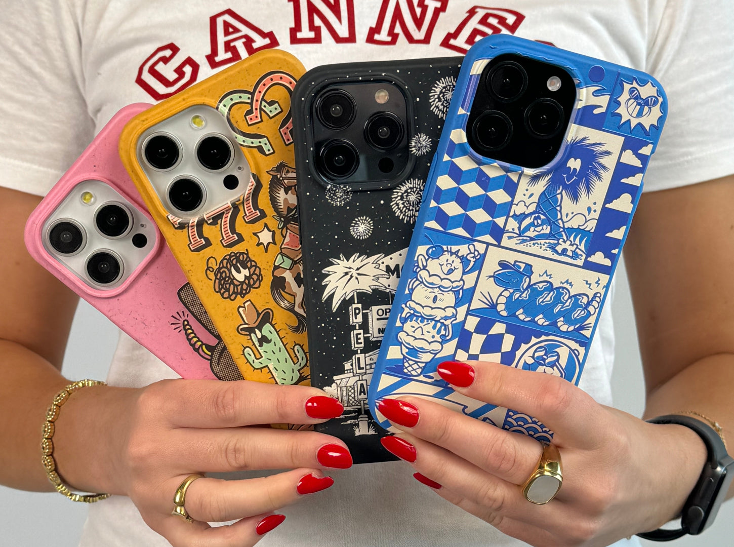 Person holding three iPhones with artistic cases, showcasing different designs.