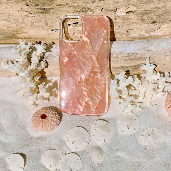 Shiny abalone peach seashell case sitting in sand