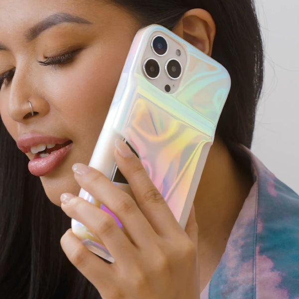 Dark haired woman calling friend using pretty white opal covered iphone