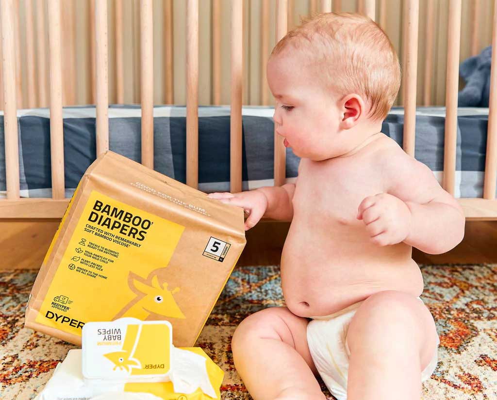 Baby wearing diaper that is commercially compostable