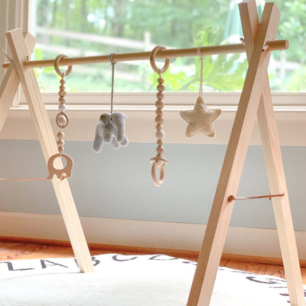 Wooden infant play gym with hanging elephant toy