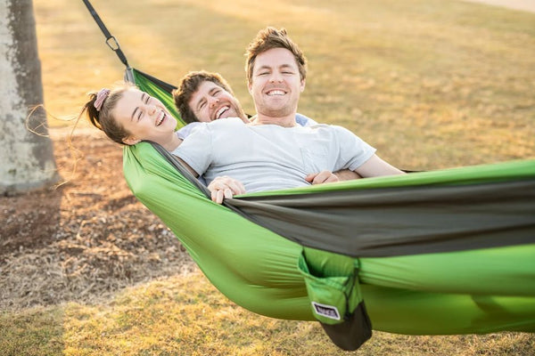 Dad smiling with family in recycled hammock