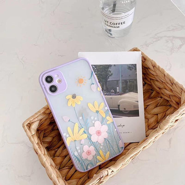 A floral phone case sitting in a basket next to an old photo