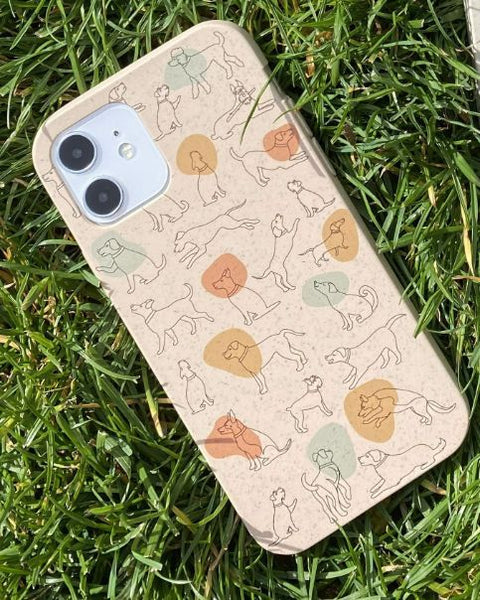 iphone case with dogs drawn on it sitting on the grass