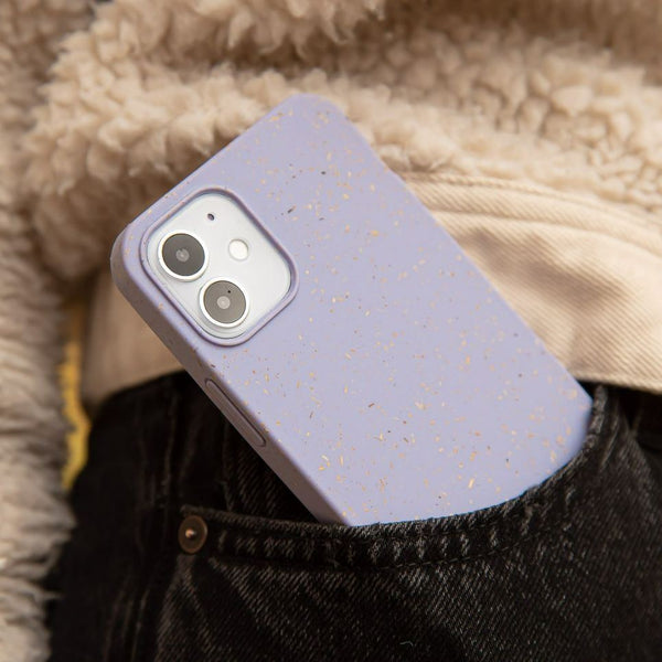 A phone in a lavender Pela case sticking out of a pocket