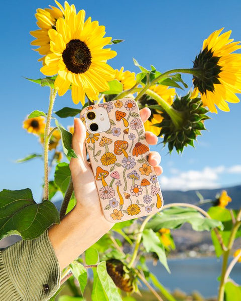 A phone in a seashell shrooms and blooms Pela case