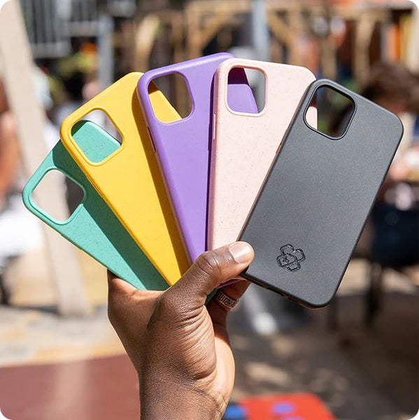 Someone holding up a handful of Reboxed phone cases in different colors