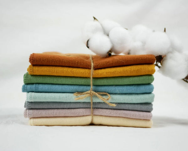 A stack of brightly colored cotton paper towels