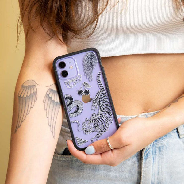 Drawings of a tiger, cherries and dice on a clear phone case