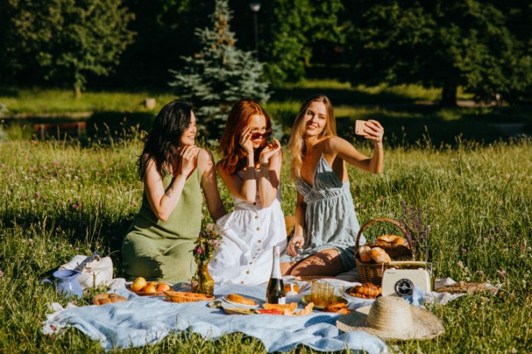 Three girls taking a selfie at a picnic