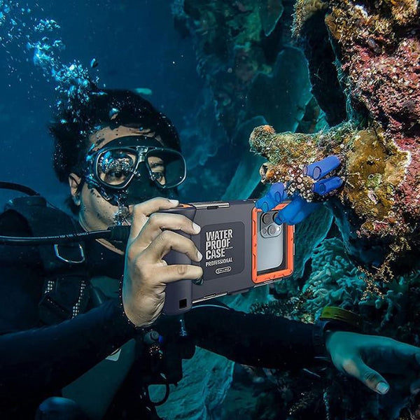 A man in a scuba suit holding an underwater camera snapping a photo