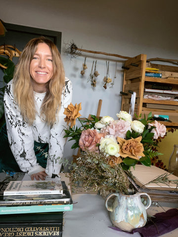 owner of business pressing flowers, preserving wedding bouquets
