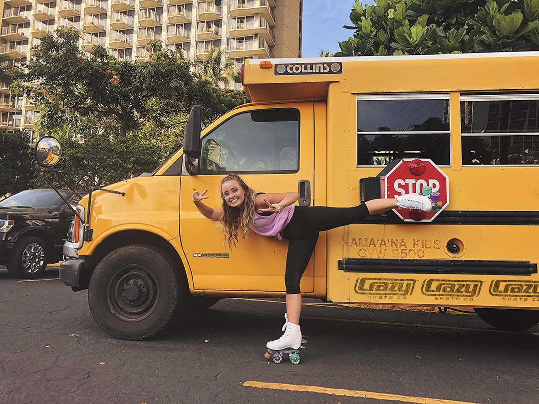 girl skating with yellow school bus