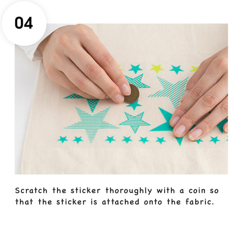 Scratch the Irodo sticker thoroughly with a coin so that the sticker is attached onto the fabric.