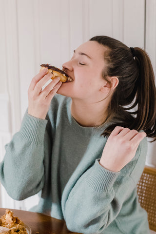 A woman biting chocolate muffin I Chocolate day I Chocolate brooch