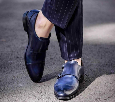 Blue monk shoes with navy blue suit close up