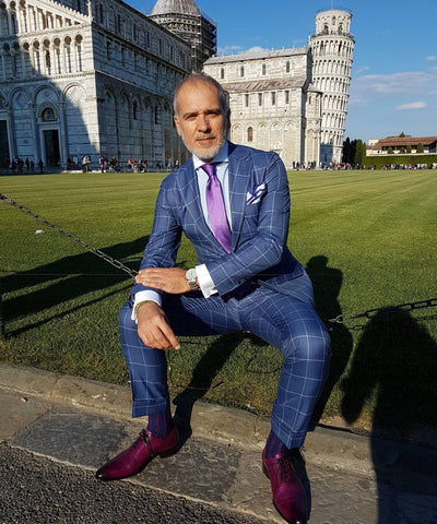 Suited Traveller wearing Thomas Bird plum wholecuts with a blue windowpane suit