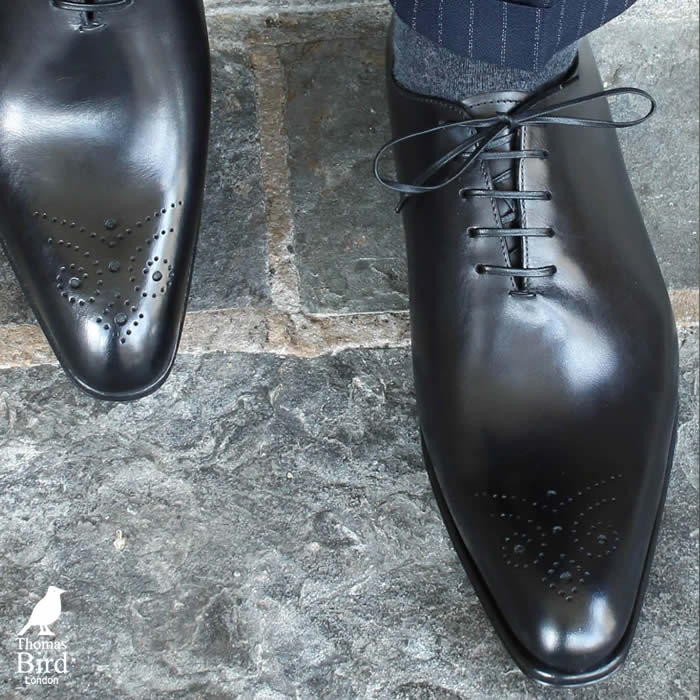 Black brogue wholecuts with a navy blue suit