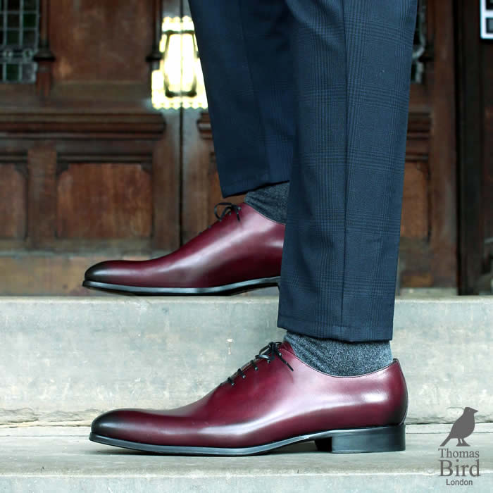 Oxblood wholecuts worn with a navy blue suit