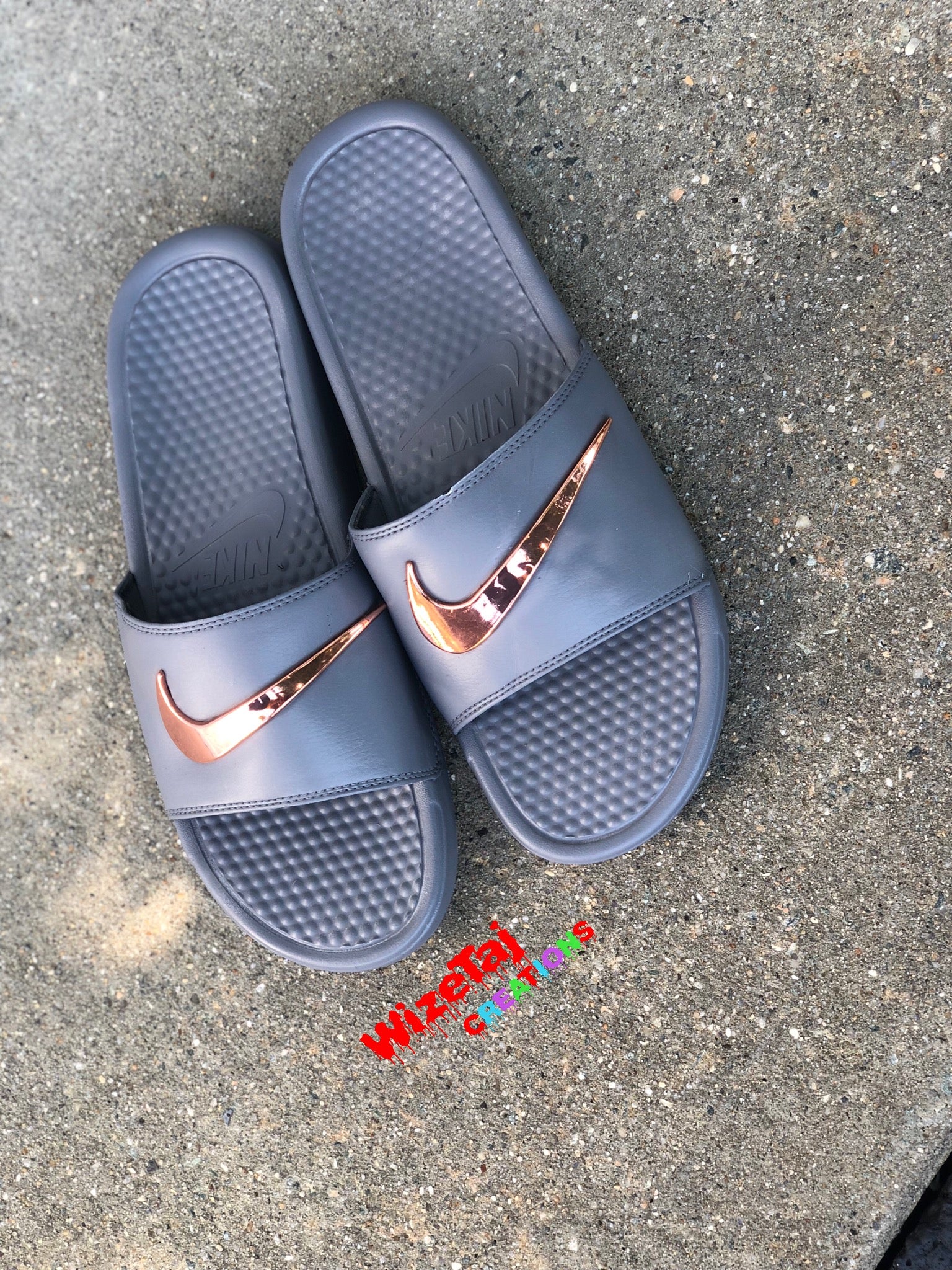 burgundy nike slides with gold nike sign