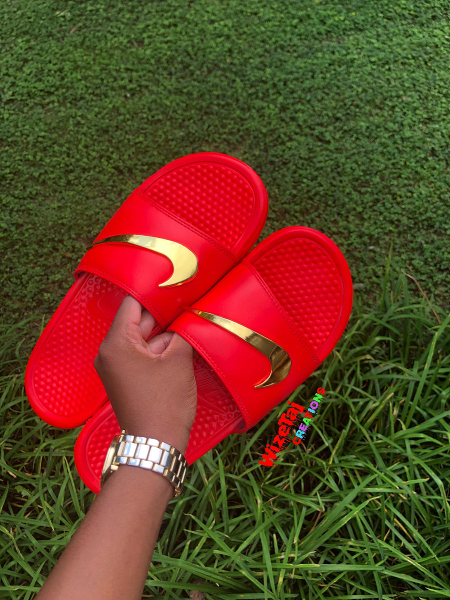 red nike slides with gold check