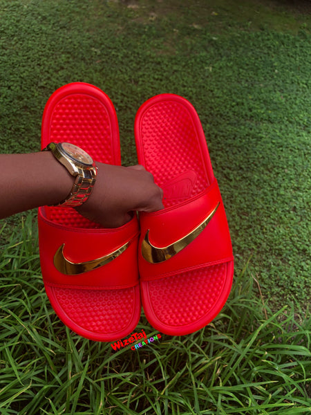 red nike slides with gold check