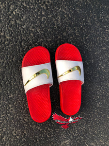 red nike sandals with gold check