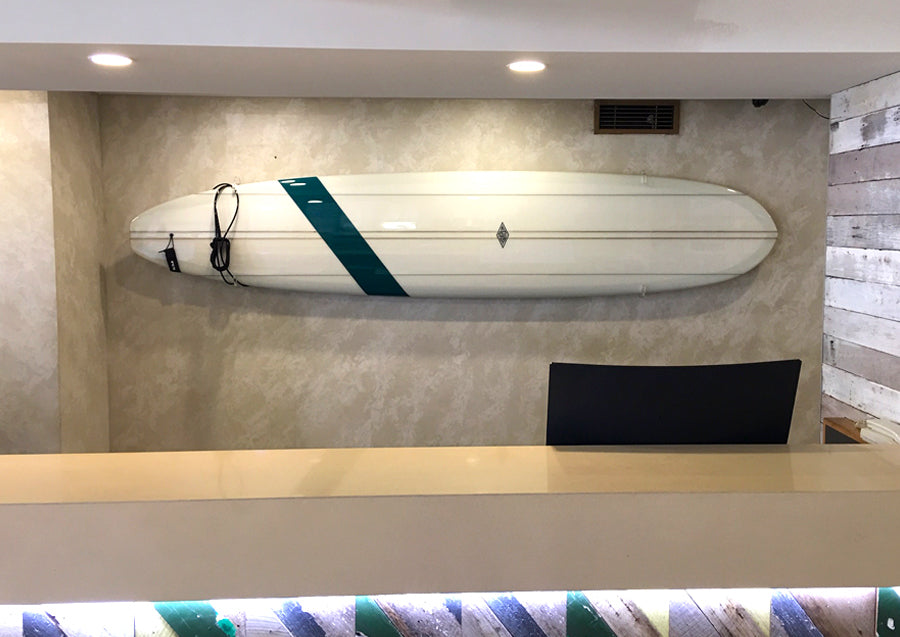 Surfboard in racks behind reception