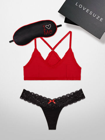 Flat lay of the 3 Piece Snoozing Beauty Set, which includes the Cotton Red NoHo Scoop Racerback Bralette, Black SUZE® Lace Thong, and I Love Me Satin Sleep Mask.