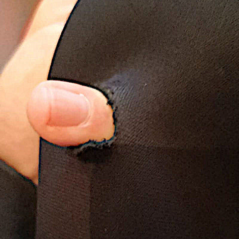 Winter wetsuit with a finger passing through a hole