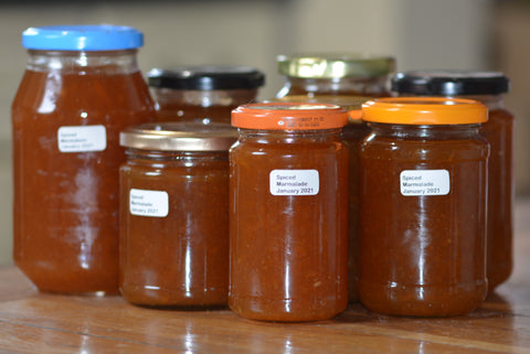 The freshly made marmalade was potted up in a variety of reused jars.