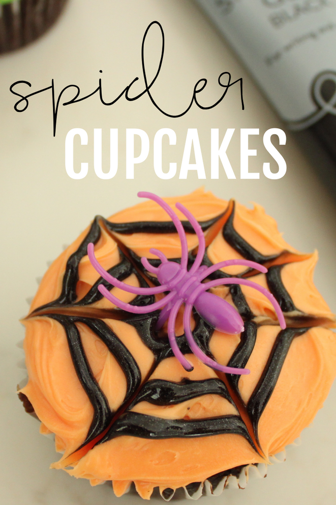 How make chocolate cupcakes with orange buttercream, black spider web icing and purple spider ring.