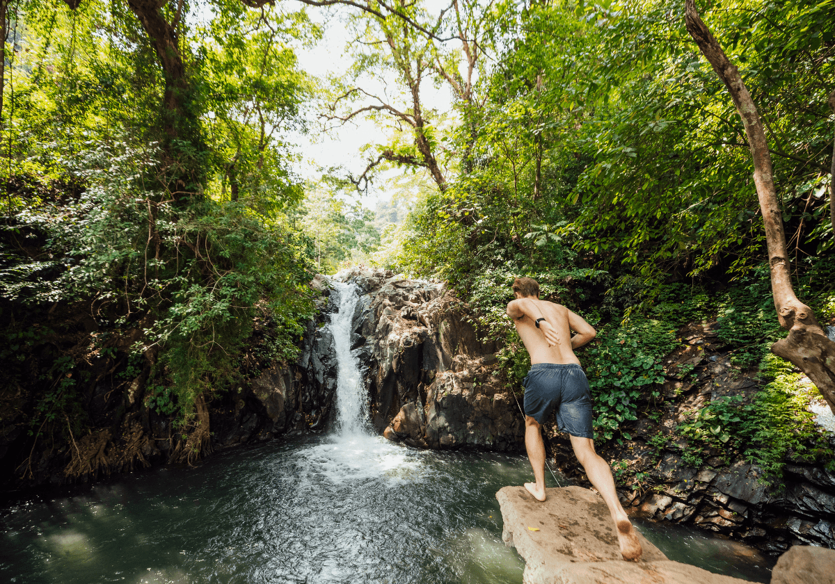 a man jumping in a lake