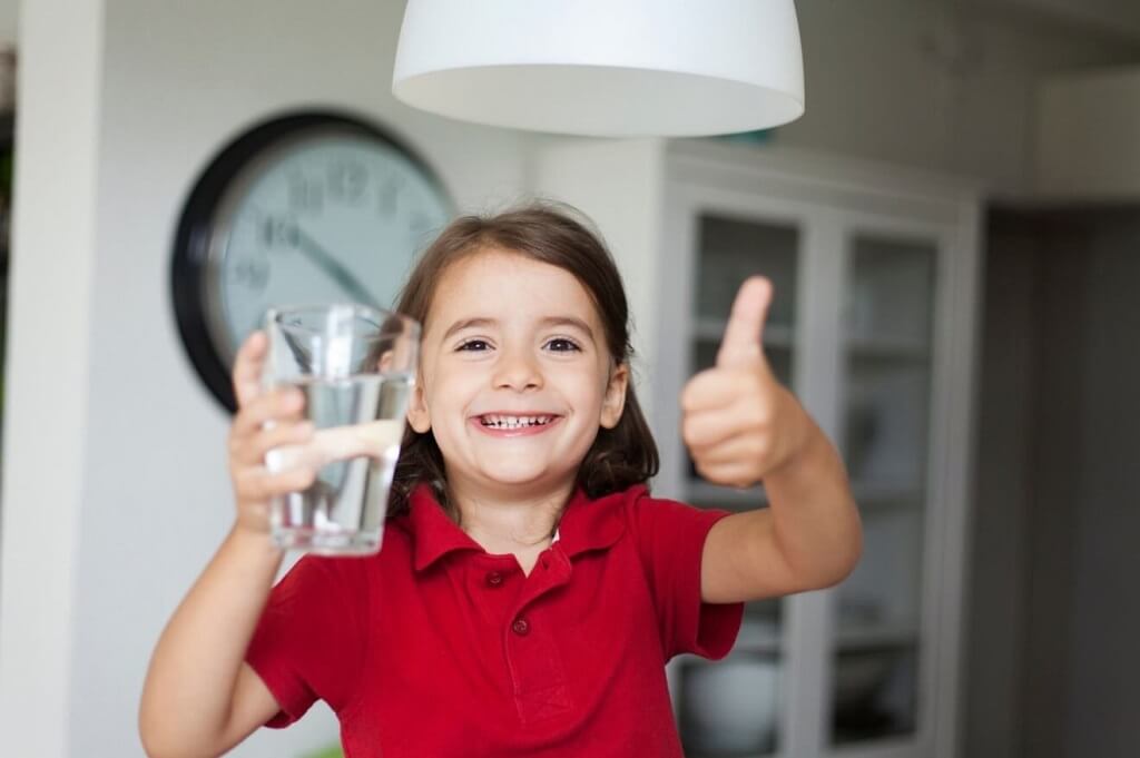 a girl with a glass of water