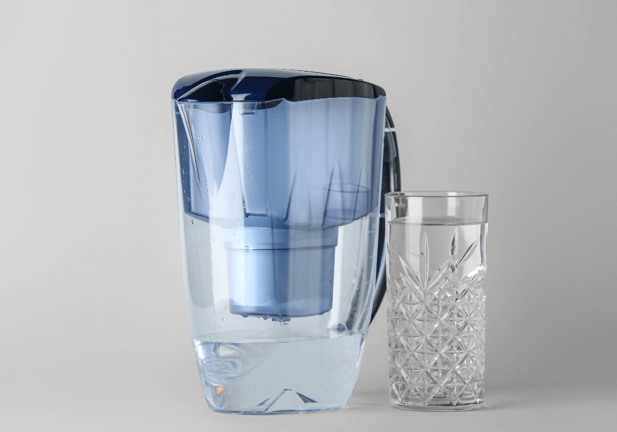 a water pitcher and a glass