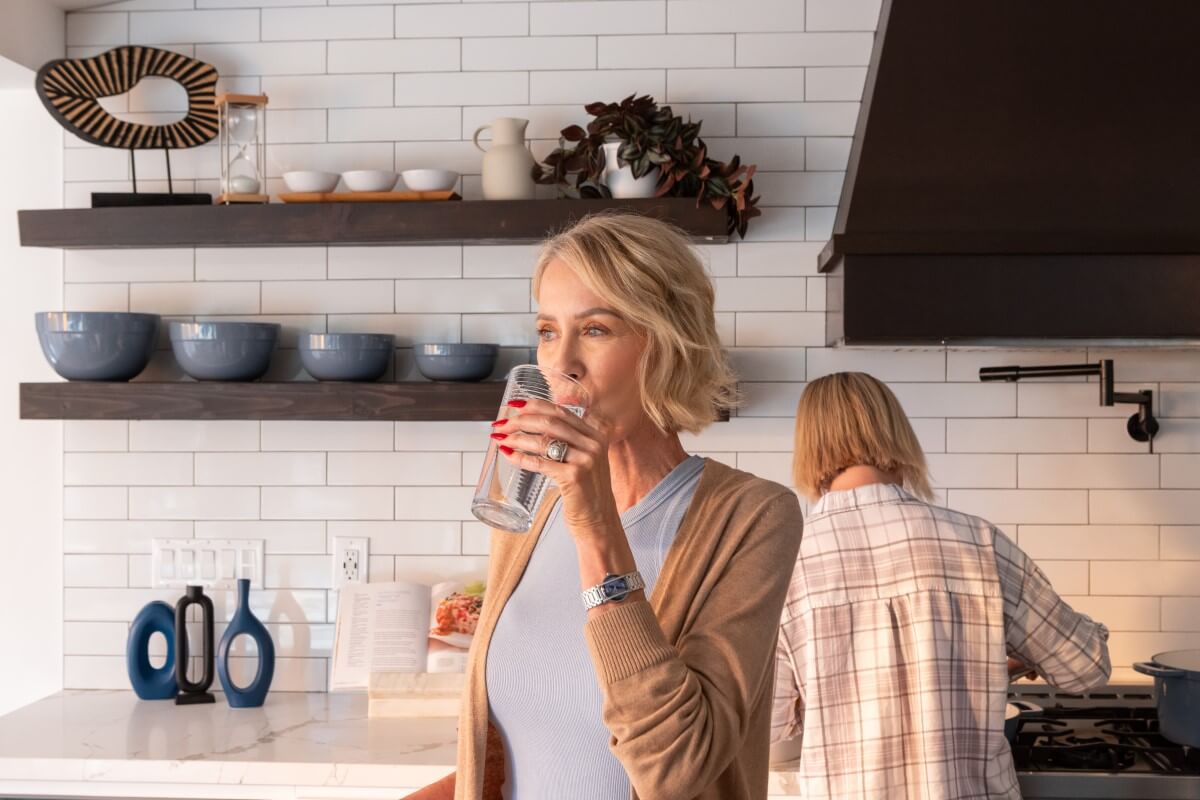 a woman drinking alkaline water