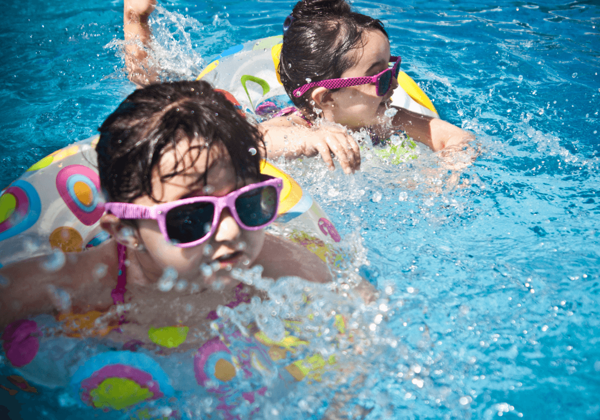 children swimming in pool