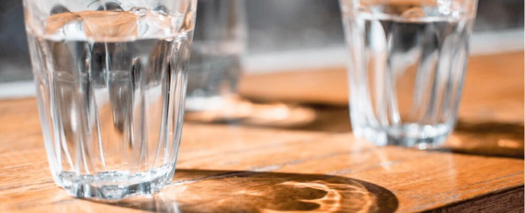 glasses of water on a wooden table