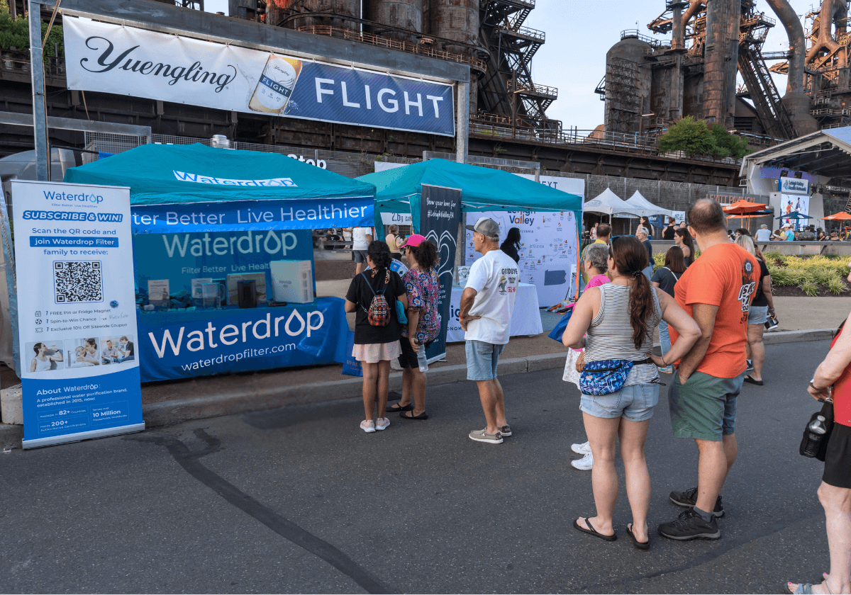 many people lined up in front of the Waterdrop stand