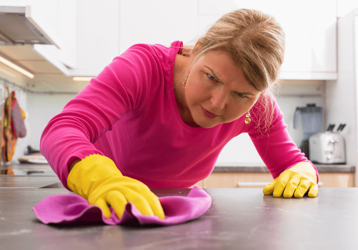 a woman cleaning hard water stains