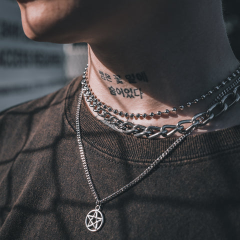 tattooed model wearing punk rock necklaces