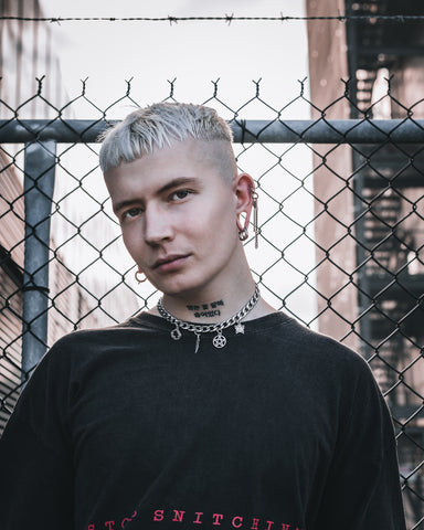 Male model with cuban link choker necklace in urban location